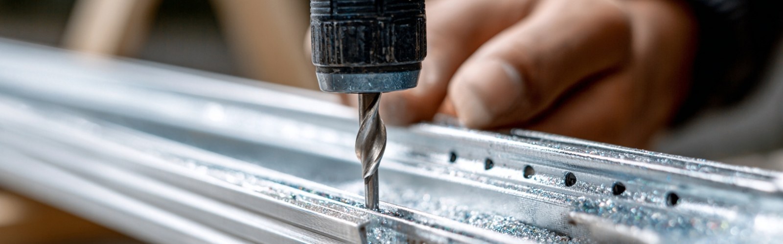 Close-up of accordion shutter track installation showing precision anchor points